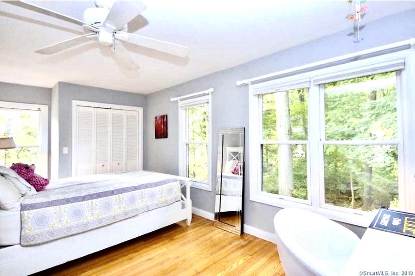 3 Little Brook Road Rowayton, CT 06853 - Photo 8 of 17 a bedroom with a bed and a large window