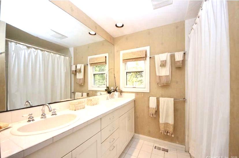 3 Little Brook Road Rowayton, CT 06853 - Photo 10 of 17 a spacious bathroom with a double vanity sink mirror and