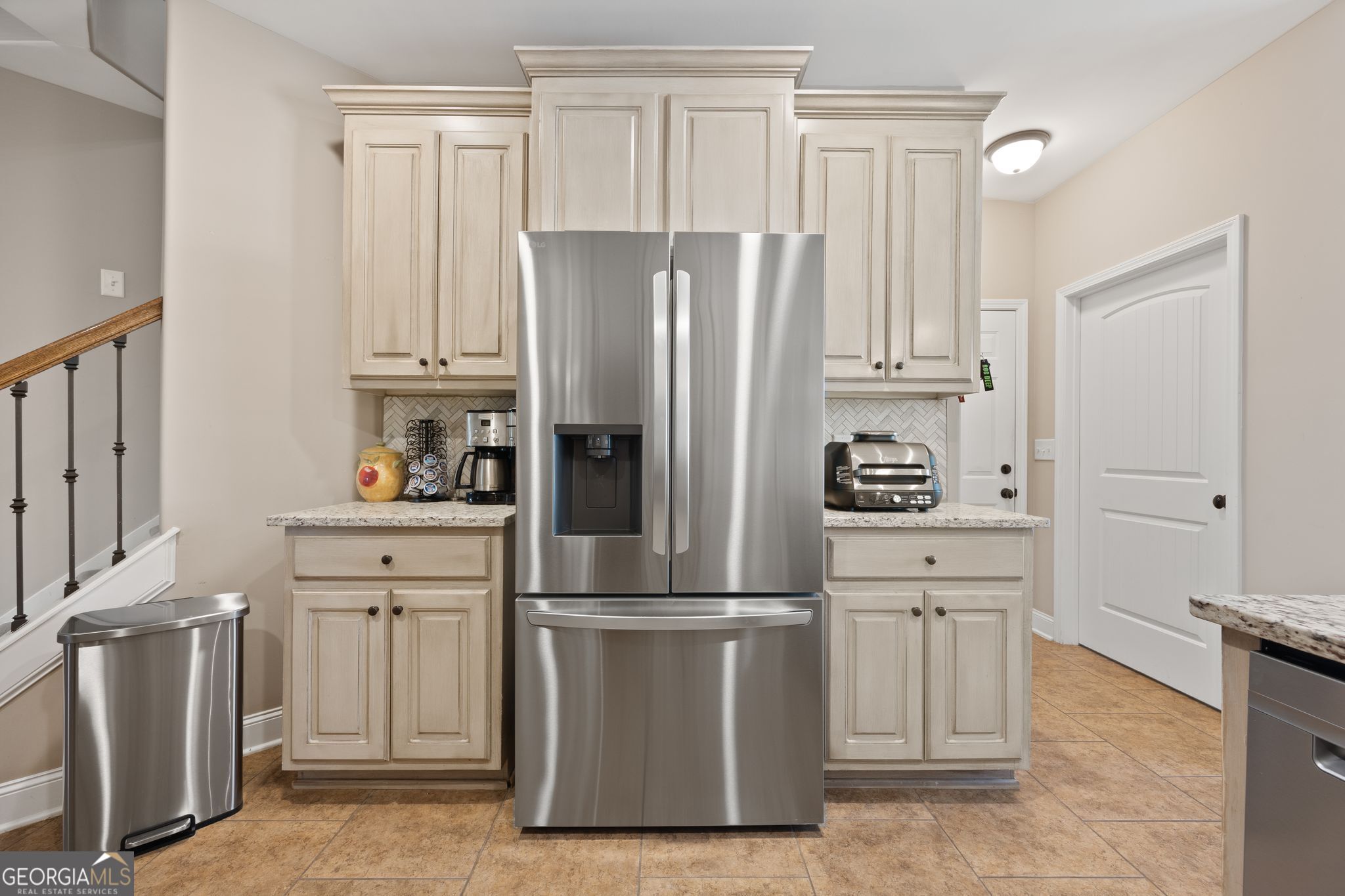 107 Sweet Bay Circle Milner, GA 30257 - Photo 12 of 31 a kitchen with cabinets stainless steel appliances and a refrigerator