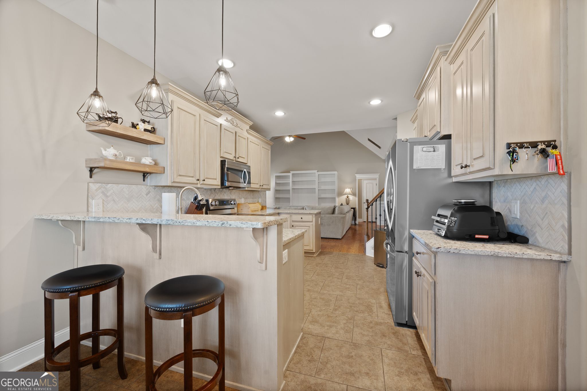 107 Sweet Bay Circle Milner, GA 30257 - Photo 13 of 31 a kitchen with cabinets and chairs