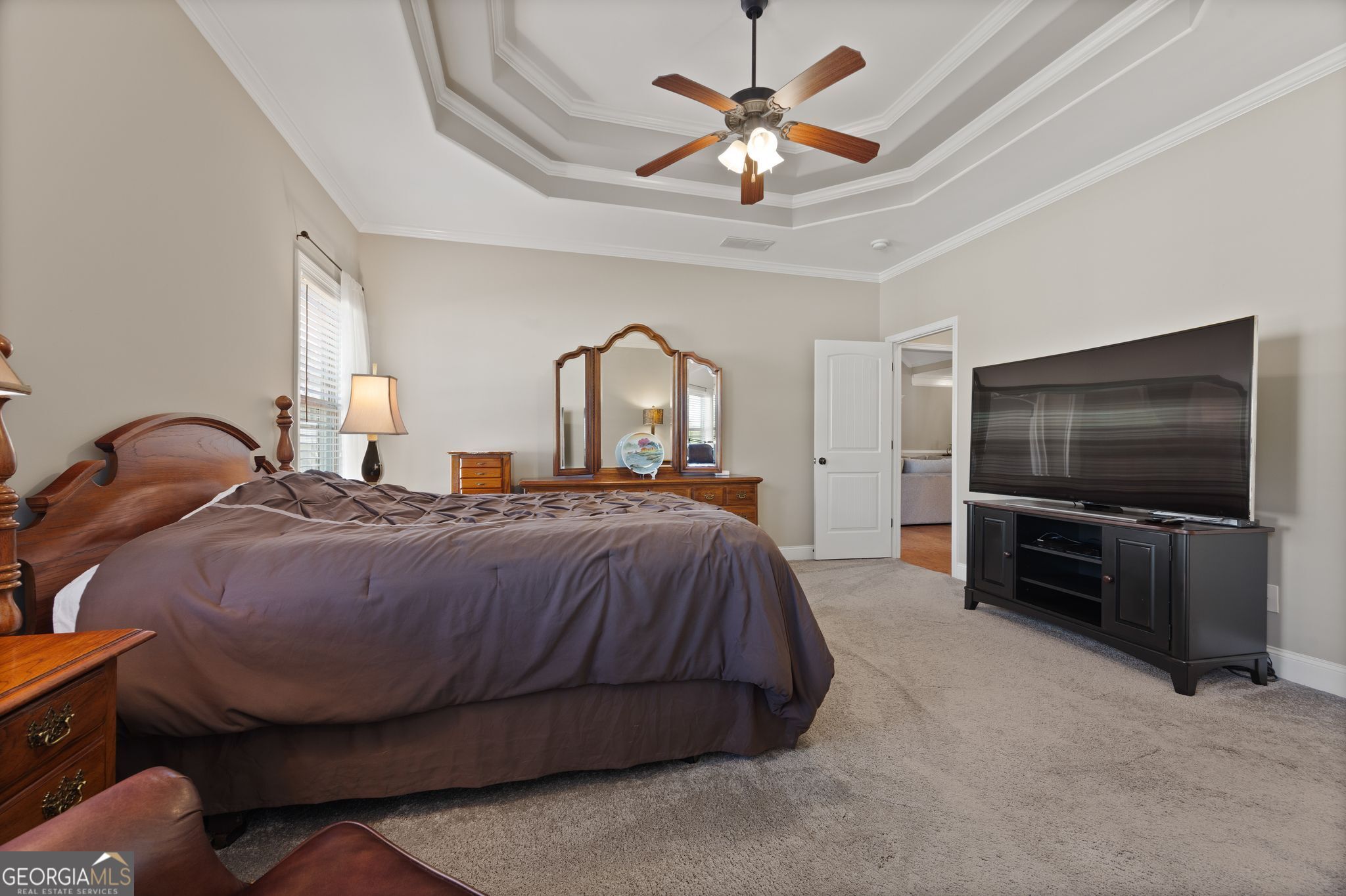 107 Sweet Bay Circle Milner, GA 30257 - Photo 17 of 31 a spacious bedroom with a bed and a flat screen tv