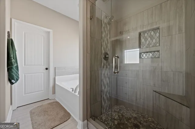 a bathroom with a shower and a tub