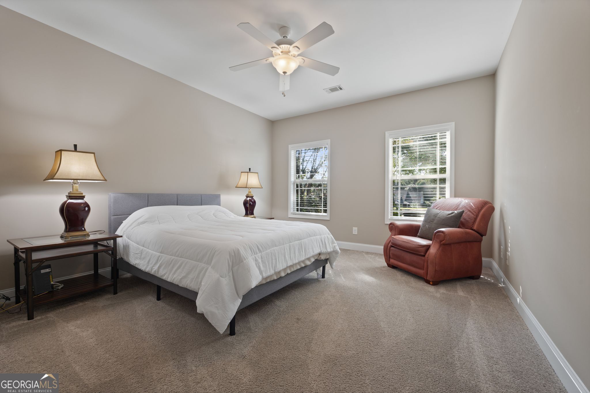 107 Sweet Bay Circle Milner, GA 30257 - Photo 22 of 31 a spacious bedroom with a bed and a couch