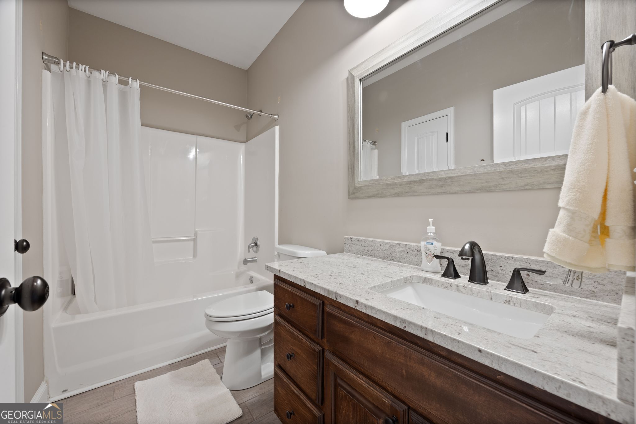 107 Sweet Bay Circle Milner, GA 30257 - Photo 23 of 31 a bathroom with a granite countertop sink a toilet and a large mirror