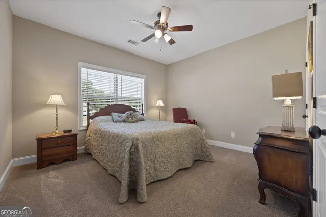 a bedroom with a bed and a chair