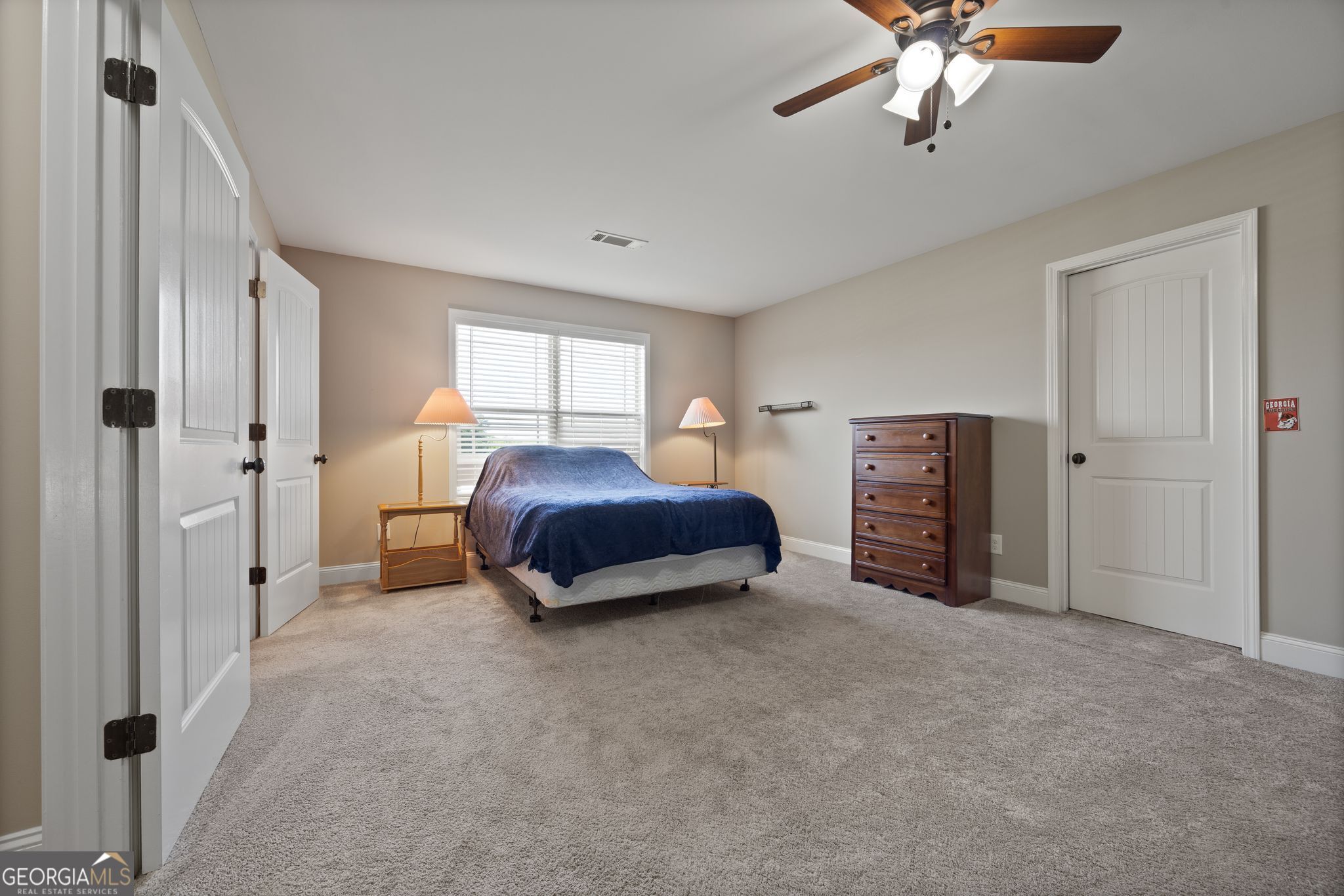 107 Sweet Bay Circle Milner, GA 30257 - Photo 25 of 31 a spacious bedroom with a bed and a chandelier