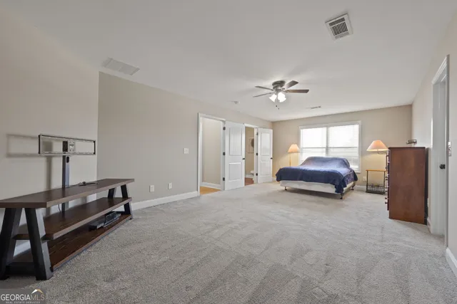 a living room with furniture and a ceiling fan