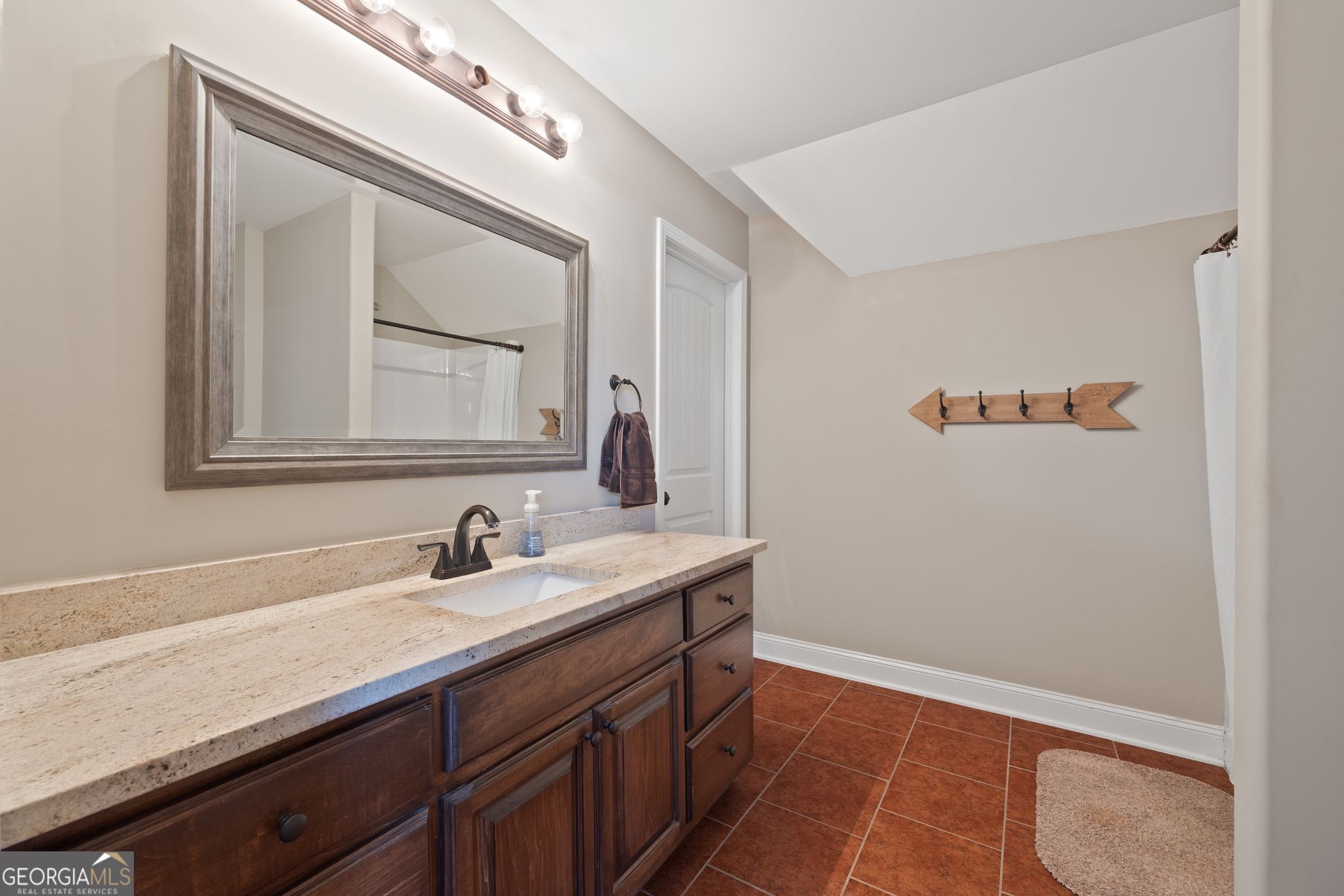 107 Sweet Bay Circle Milner, GA 30257 - Photo 27 of 31 a bathroom with a sink a vanity and a mirror