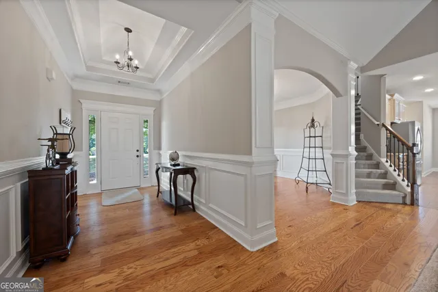a view of a room with wooden floor and stairs