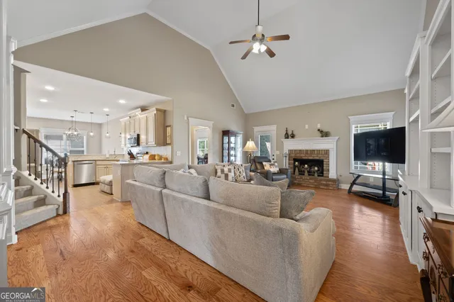 a living room with furniture a fireplace and a flat screen tv