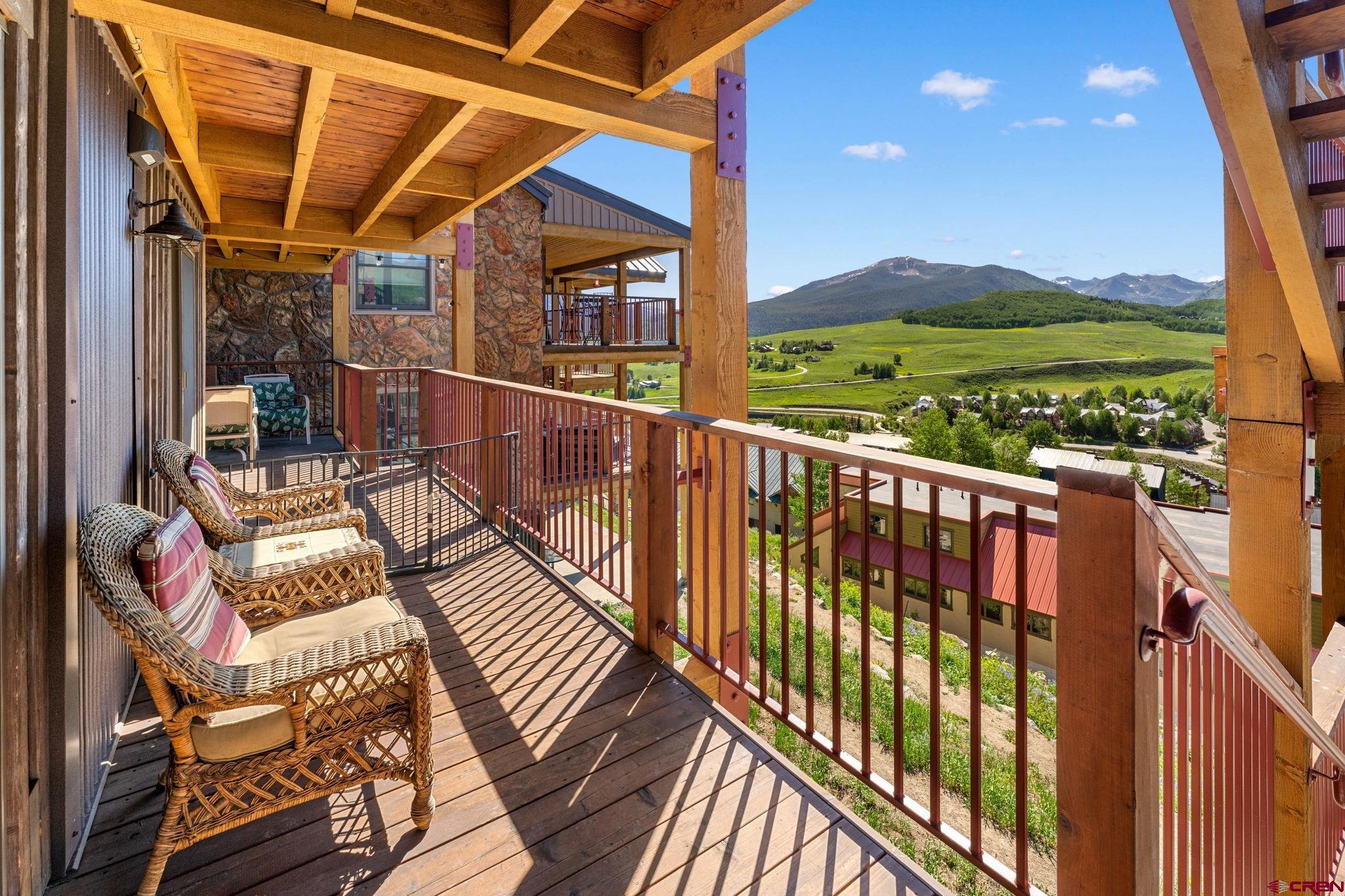 72 Hunter Hill Road, Unit I204 Crested Butte, CO 81225 - Photo 25 of 44 a view of balcony with wooden floor and outdoor seating