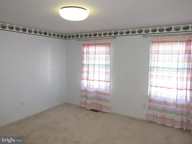 a view of a room with window and a ceiling fan