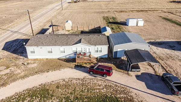 a kitchen with stainless steel appliances granite countertop a stove top oven a sink a dining table and chairs with wooden floor