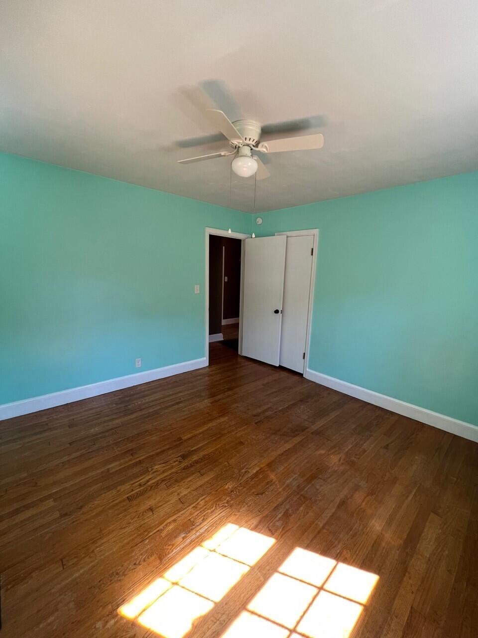 1523 Bore Auger Road Blue Ridge, VA 24064 - Photo 13 of 34 an empty room with wooden floor ceiling fan and window