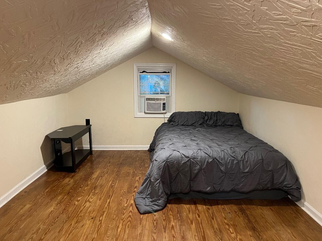 1523 Bore Auger Road Blue Ridge, VA 24064 - Photo 18 of 34 a bedroom with a bed and a wooden floor