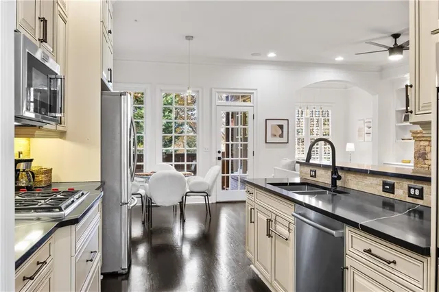 a kitchen with stainless steel appliances granite countertop a stove and a sink