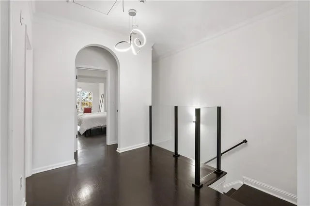 a bedroom with a large bed and a flat tv screen on dresser