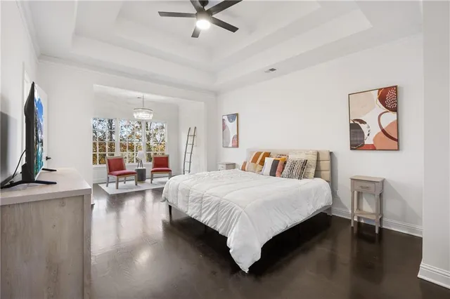 a view of a livingroom with furniture wooden floor and windows