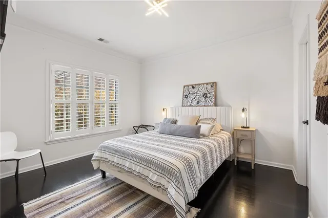 a bedroom with a bed and a painting on the wall