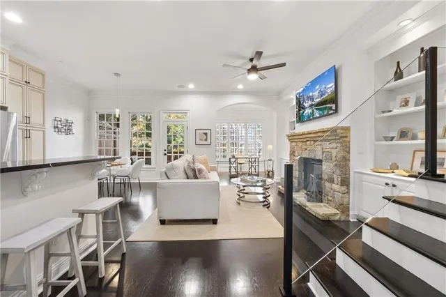 a living room with fireplace furniture and a wooden floor