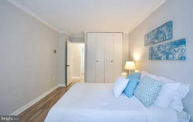 a bedroom with a bed and a painting on the wall