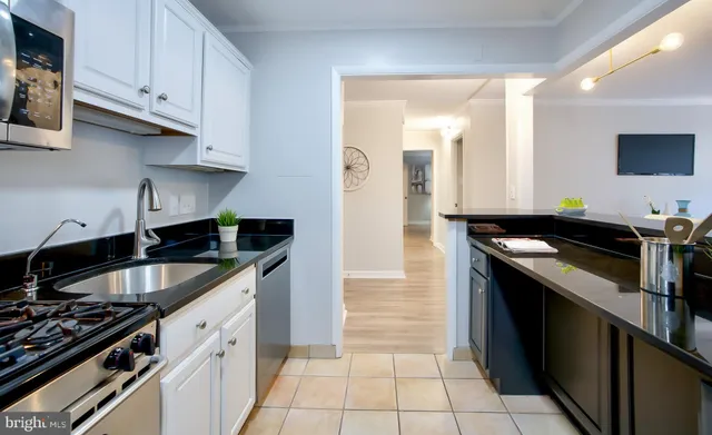 a kitchen with granite countertop a stove and a sink