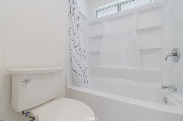 a bathroom with a toilet and a bathtub