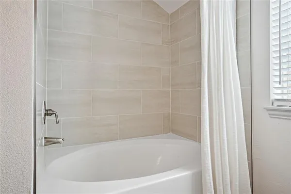 a white bath tub sitting next to a window