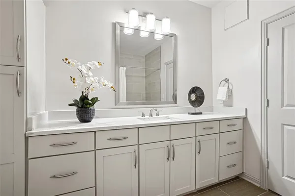 a bathroom with a sink double vanity and a mirror