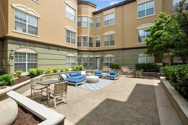 a view of a patio with couches table and chairs and potted plants