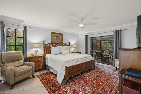 a bedroom with a bed couch and a window