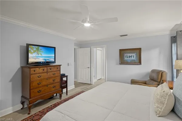 a bedroom with a bed and a television