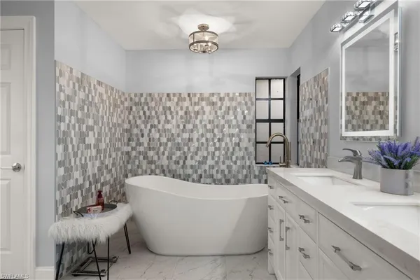 a bathroom with a bathtub a sink and a shower