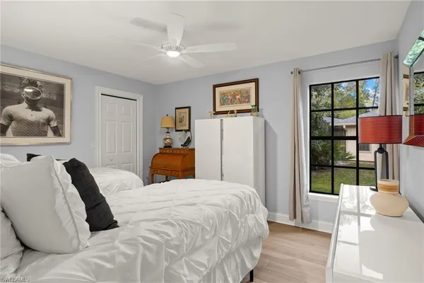 a bedroom with a bed and a painting on the wall