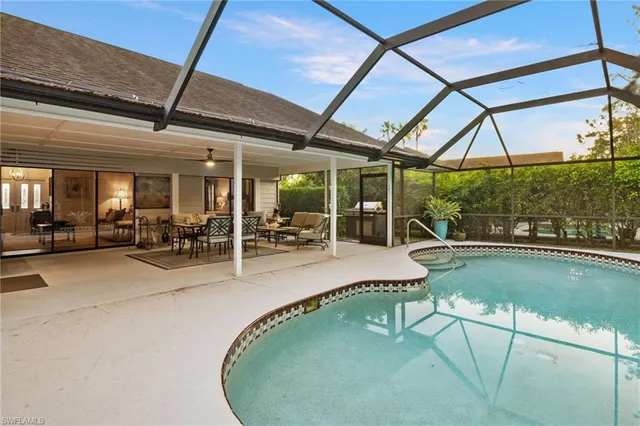 a view of a swimming pool with outdoor seating