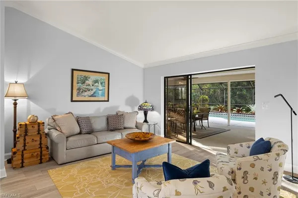 a living room with furniture and a floor to ceiling window