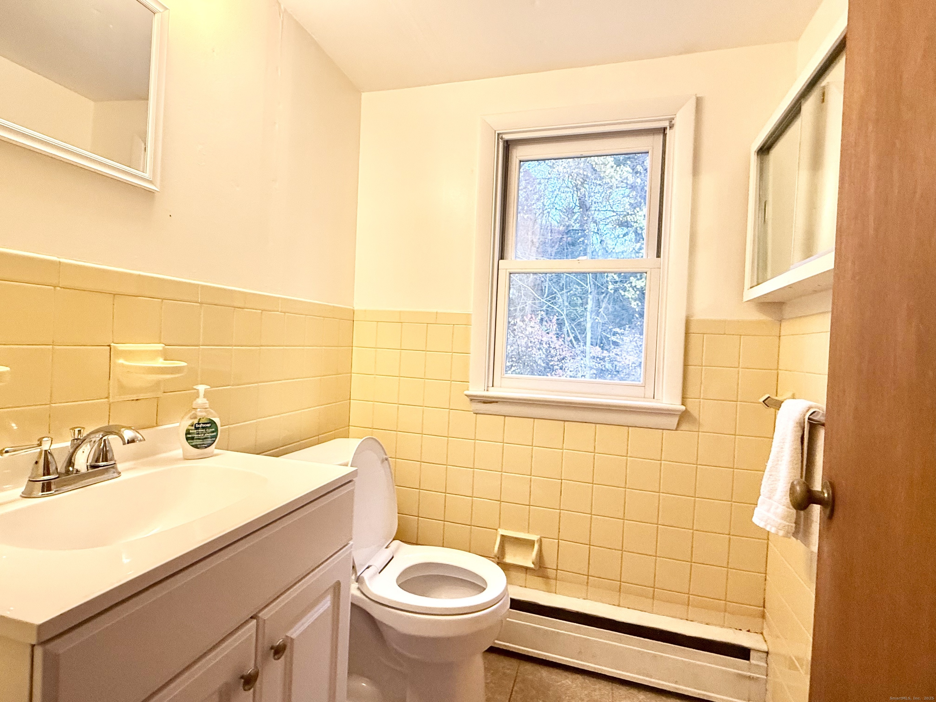 213 Georgetown Road Weston, CT 06883 - Photo 13 of 24 a bathroom with a sink mirror toilet and shower