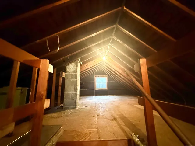 a view of a hallway with wooden walls and floor