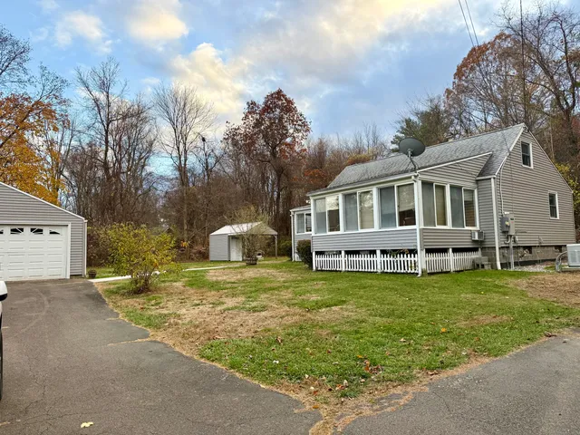 a view of a house with a yard patio and swimming pool