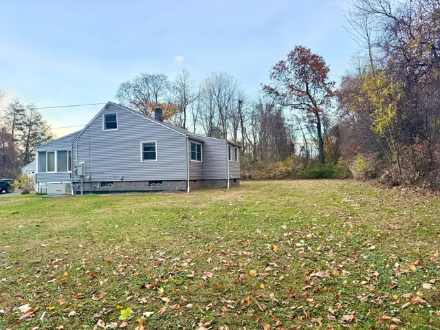 a view of house with backyard