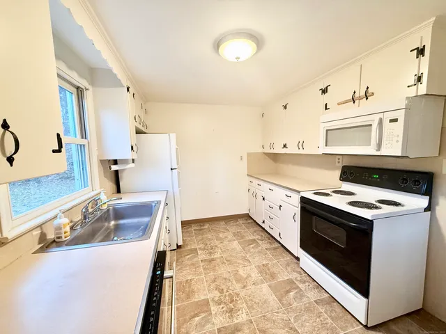 a kitchen with stainless steel appliances granite countertop a stove and a sink