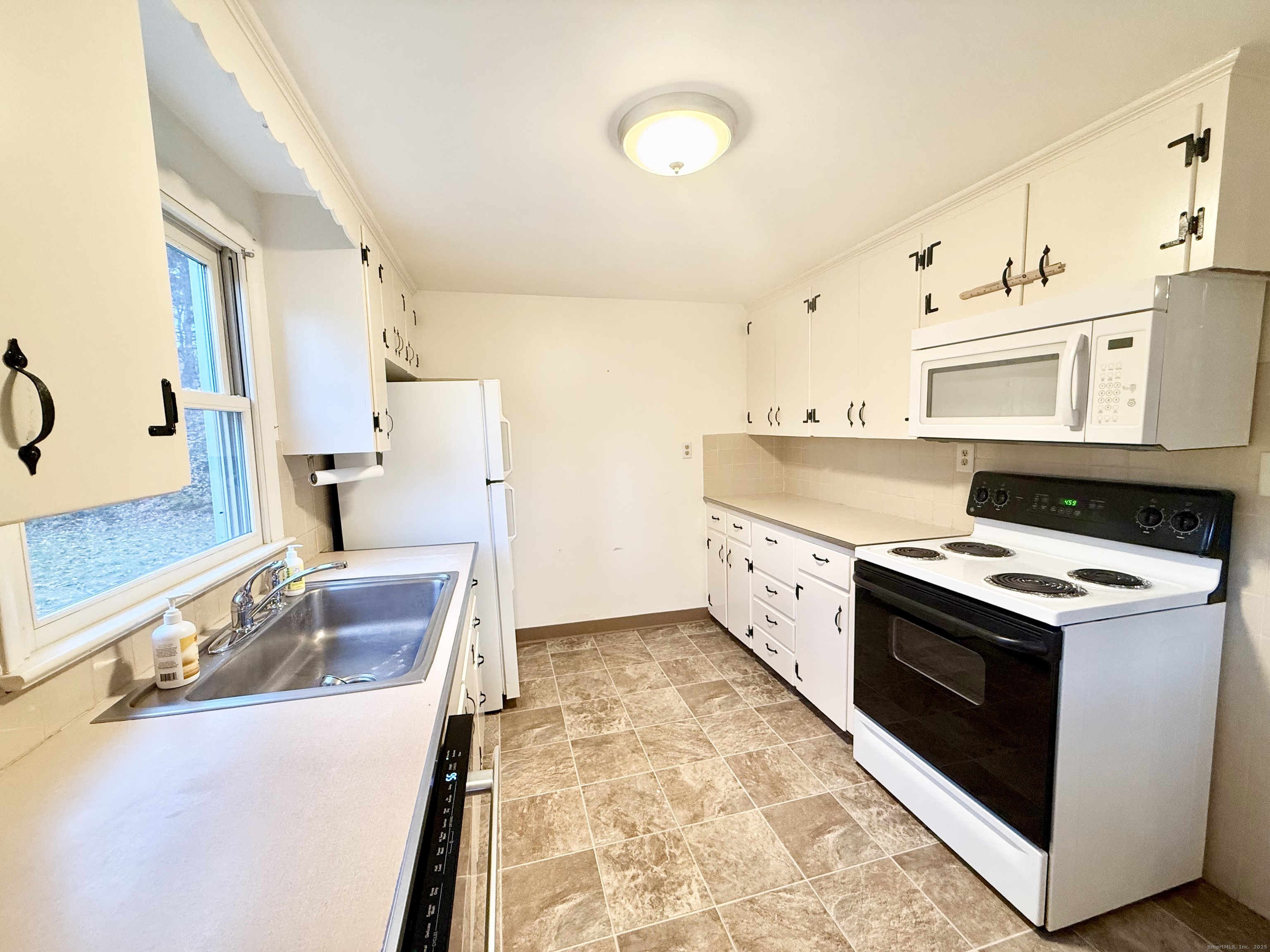 213 Georgetown Road Weston, CT 06883 - Photo 4 of 24 a kitchen with stainless steel appliances granite countertop a stove and a sink