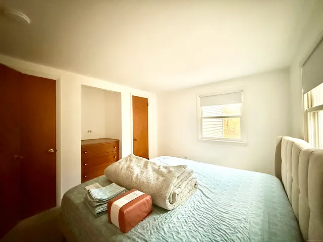 a bedroom with a bed and couch