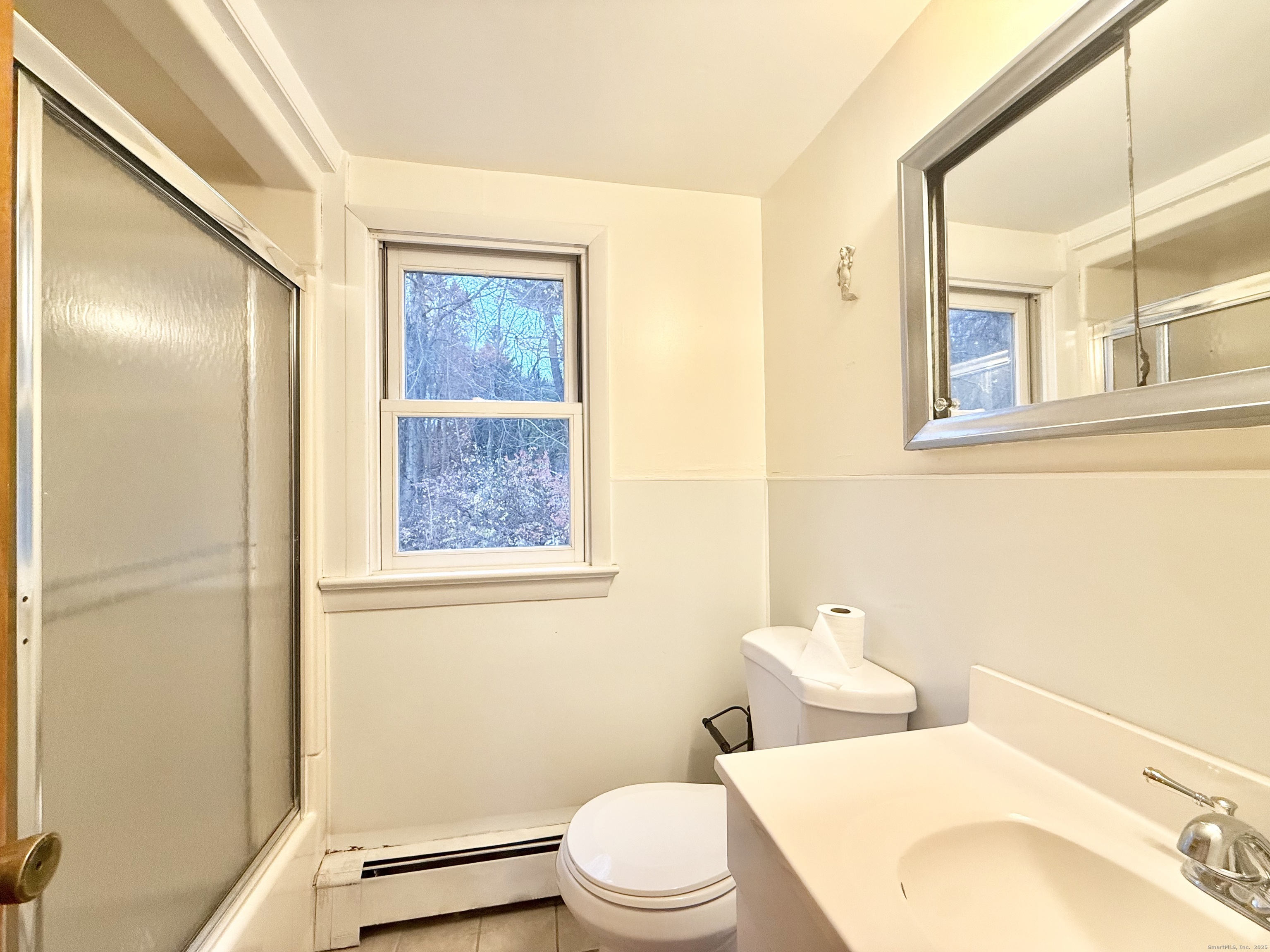 213 Georgetown Road Weston, CT 06883 - Photo 10 of 24 a bathroom with a toilet a sink and a mirror