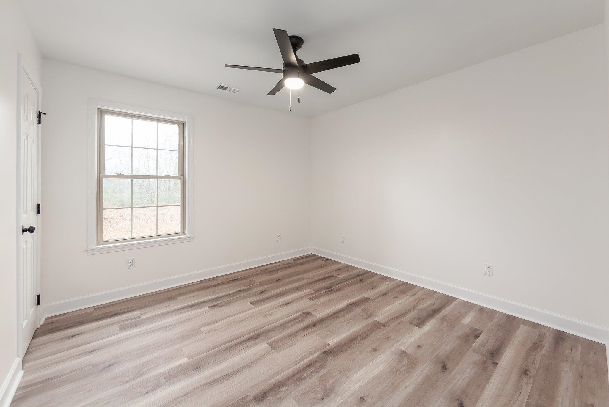 461 Summit Lane Stanton, TN 38069 - Photo 14 of 30 wooden floor in an empty room with a window