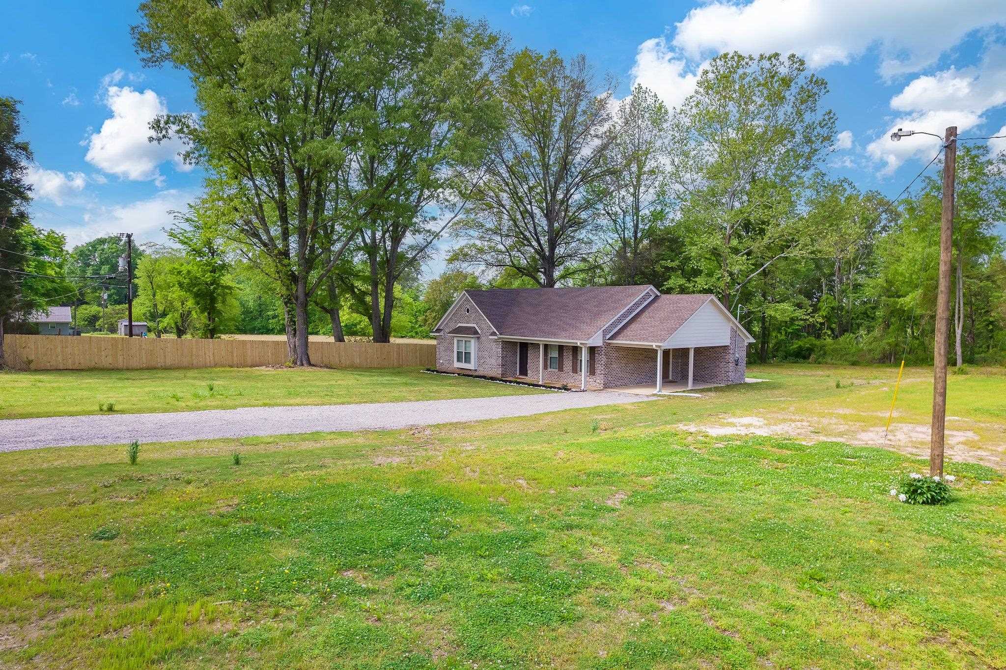 461 Summit Lane Stanton, TN 38069 - Photo 23 of 30 a view of a house with a backyard and a tree