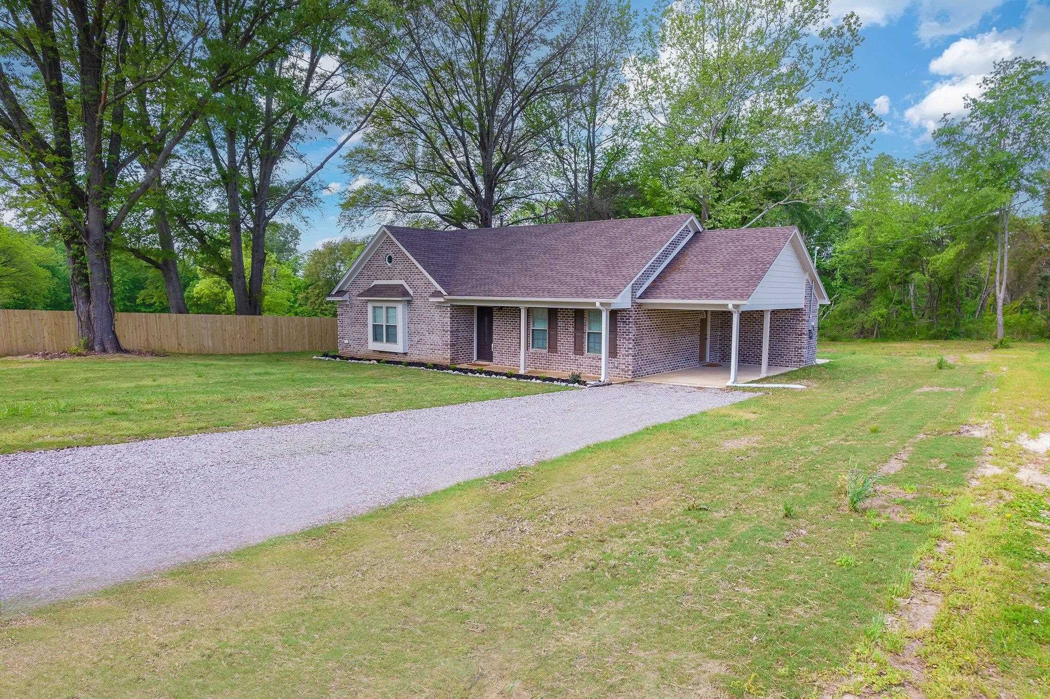 461 Summit Lane Stanton, TN 38069 - Photo 25 of 30 a front view of a house with a garden and trees