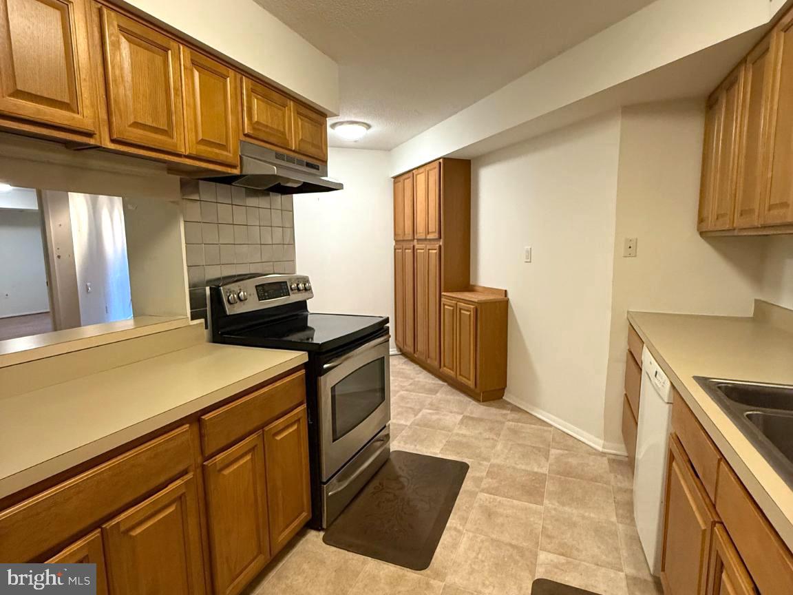 1420 Locust Street, Unit 11K Philadelphia, PA 19102 - Photo 5 of 11 Cozy kitchen with warm wood accents.