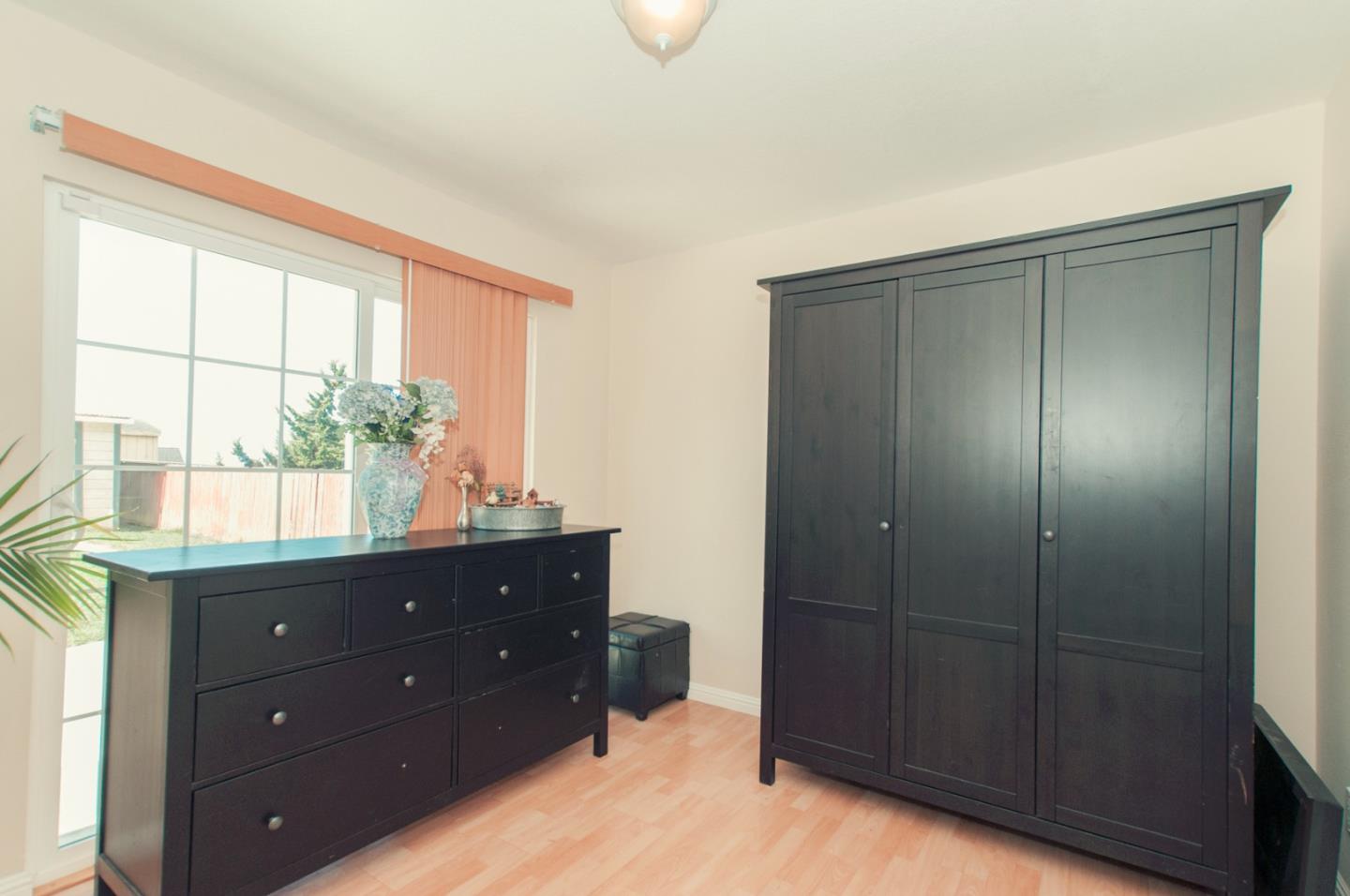 472 Inverness Drive Pacifica, CA 94044 - Photo 8 of 22 a room with a dresser and a window