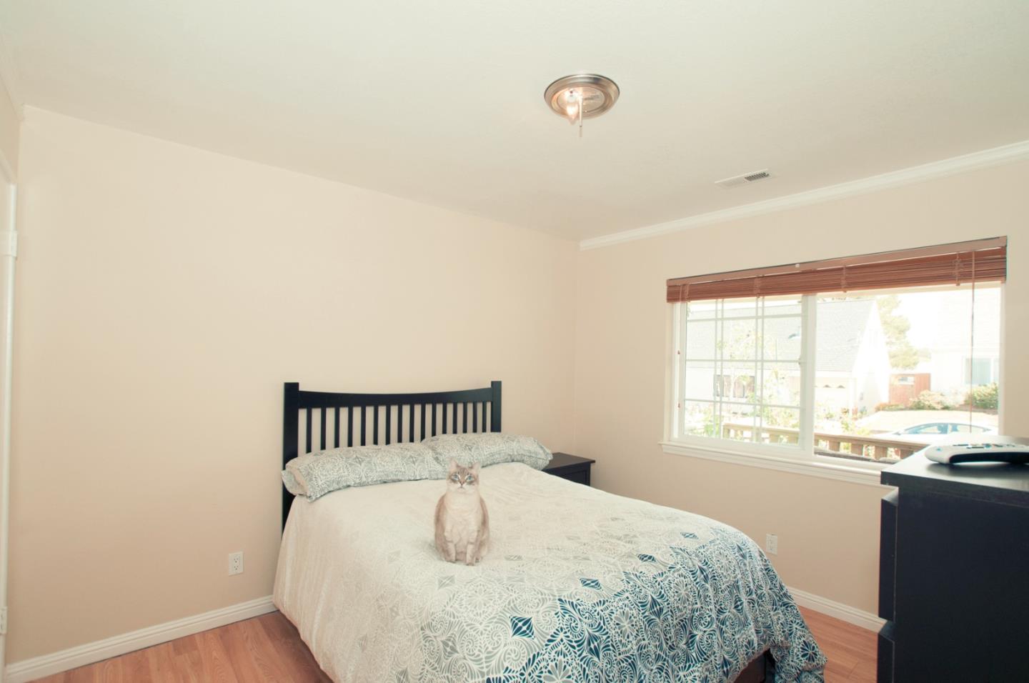 472 Inverness Drive Pacifica, CA 94044 - Photo 9 of 22 a bedroom with a bed and a window